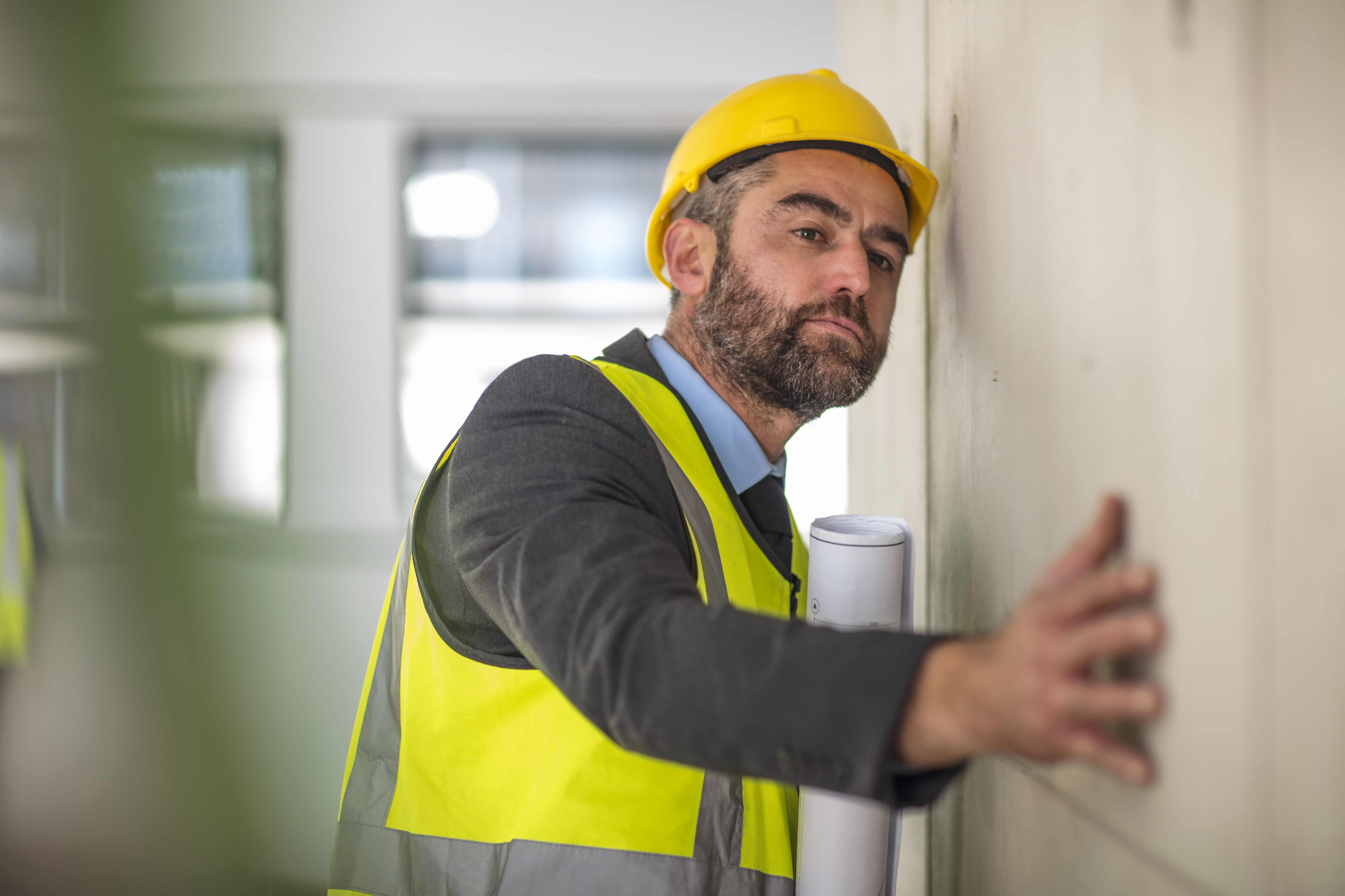 Man Holding Blueprint Surveying Wall 2022 03 08 00 18 01 Utc